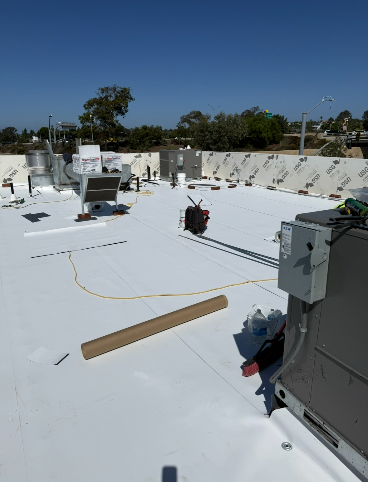 Commercial roof membrane installation with HVAC units